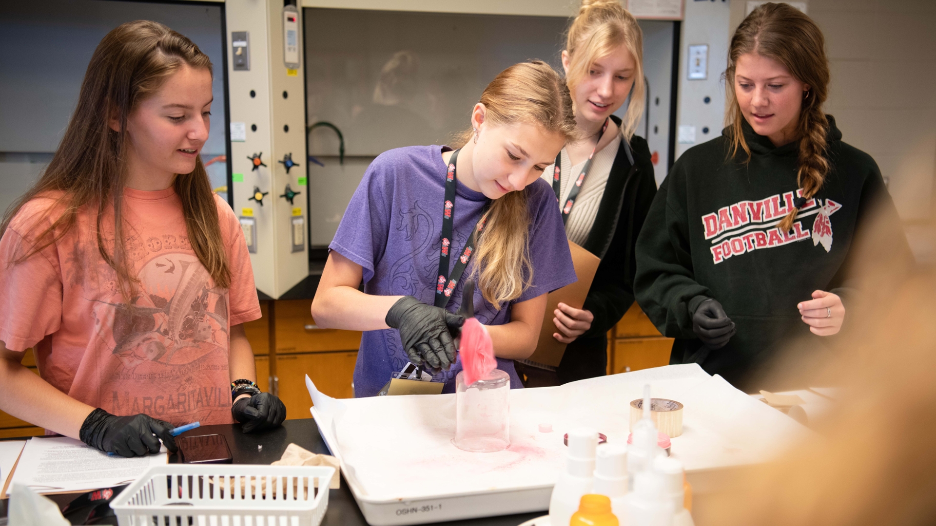 A group of students work together in a forensics lab