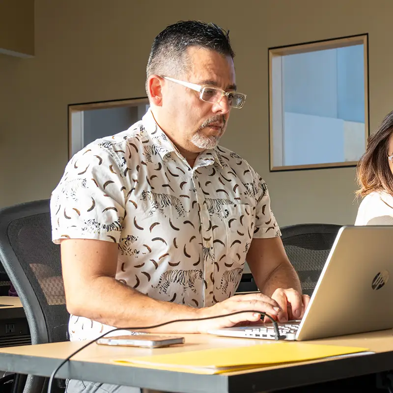 Male IWU student on laptop