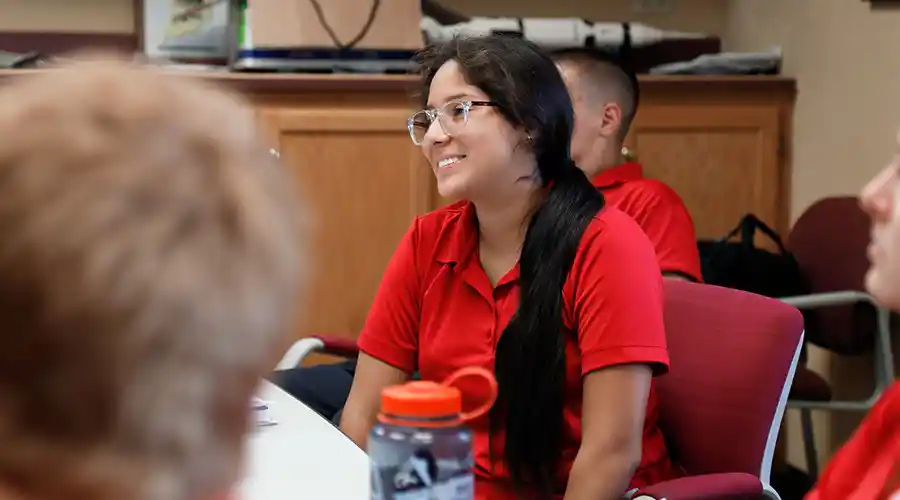 Professor working with group of students in the classroom