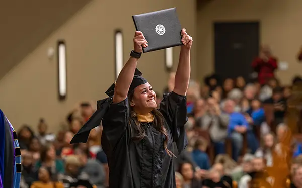 Graduate holding diploma