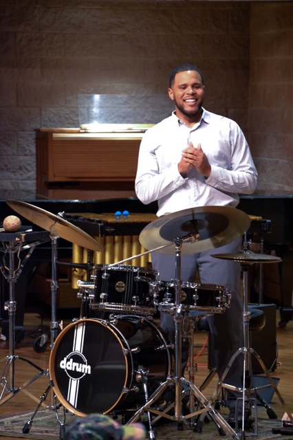Morrell standing behind a drum set
