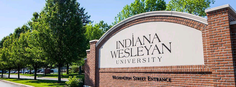 The engraved stone sign for Indiana Wesleyan University at the entrance to the university