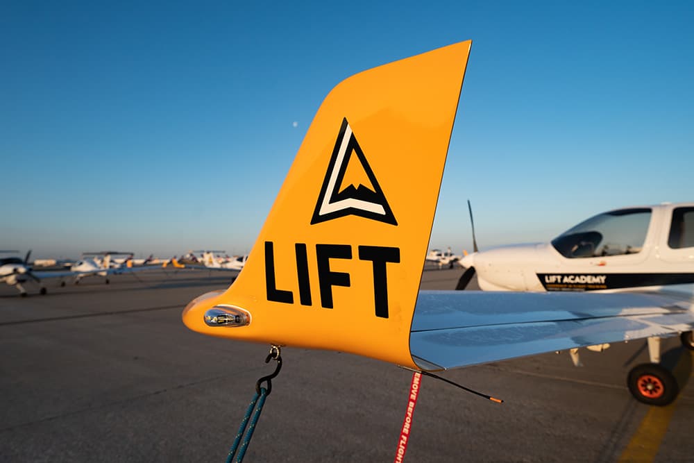 Wing of plane with lift logo