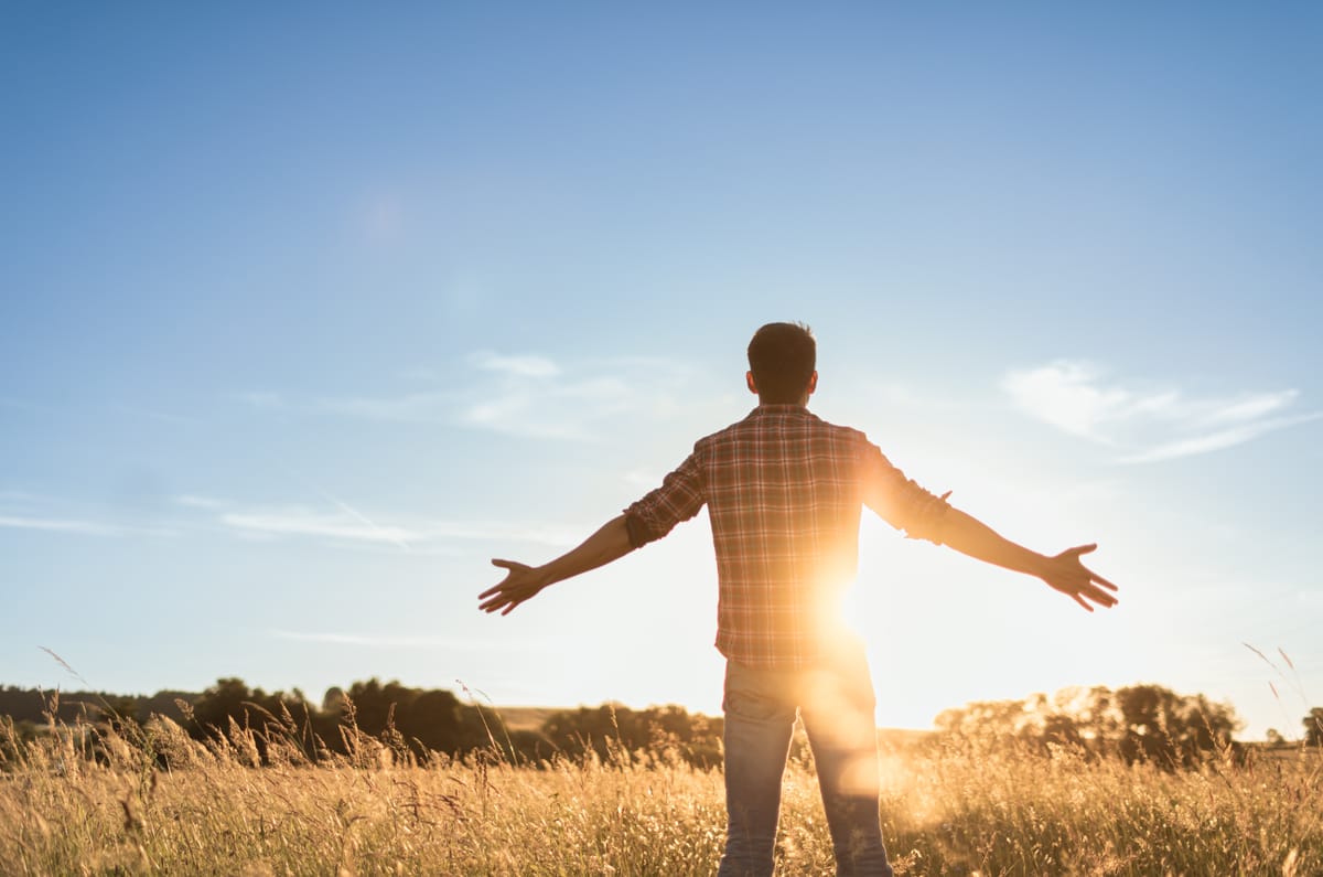 Man with arms spread wide in prayer or worship