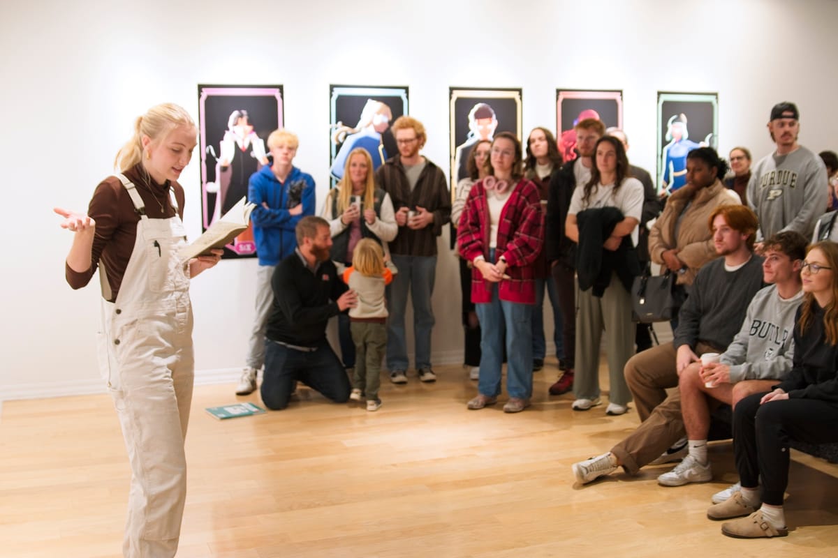 Student presenting in front of a group of people in the 1920 Gallery in IWU Student Center