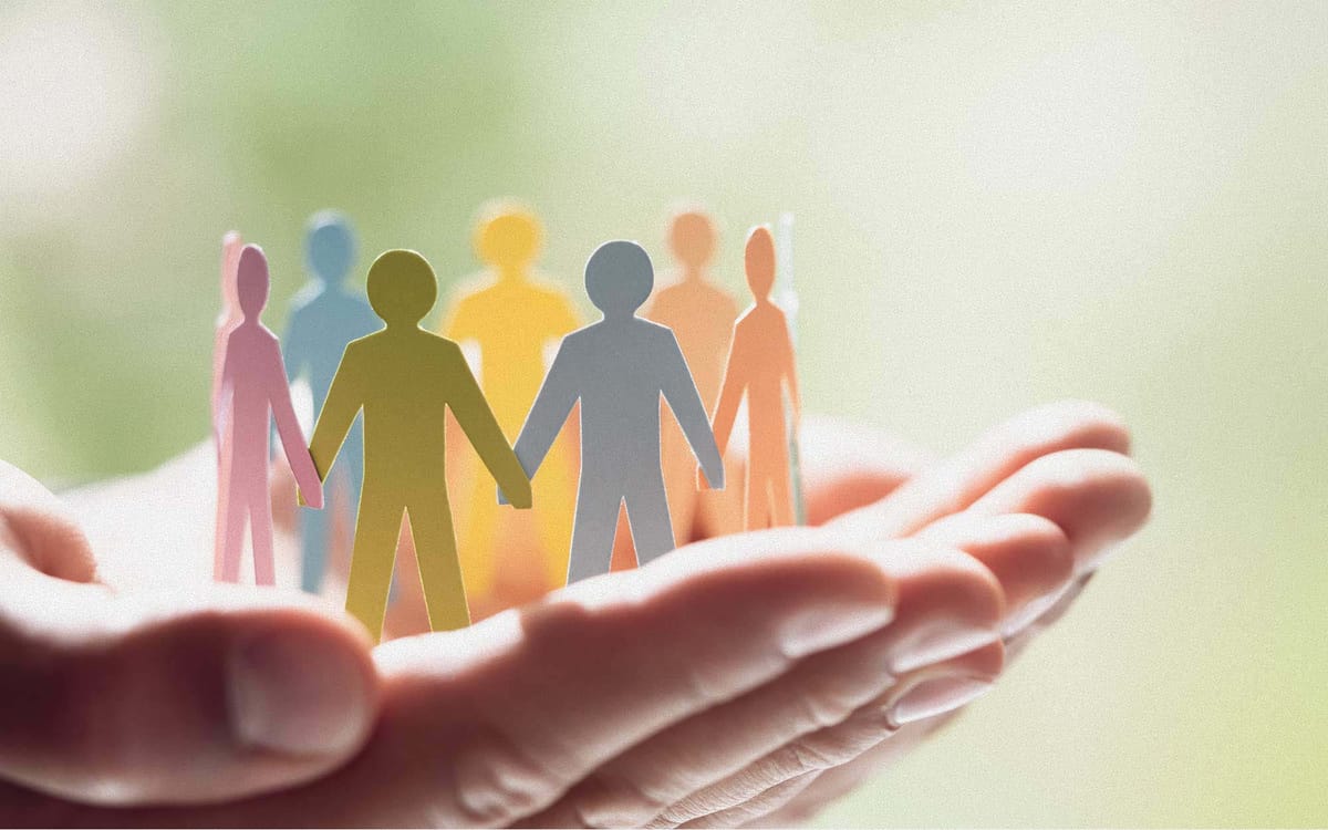 Person holding paper chain of people-figures