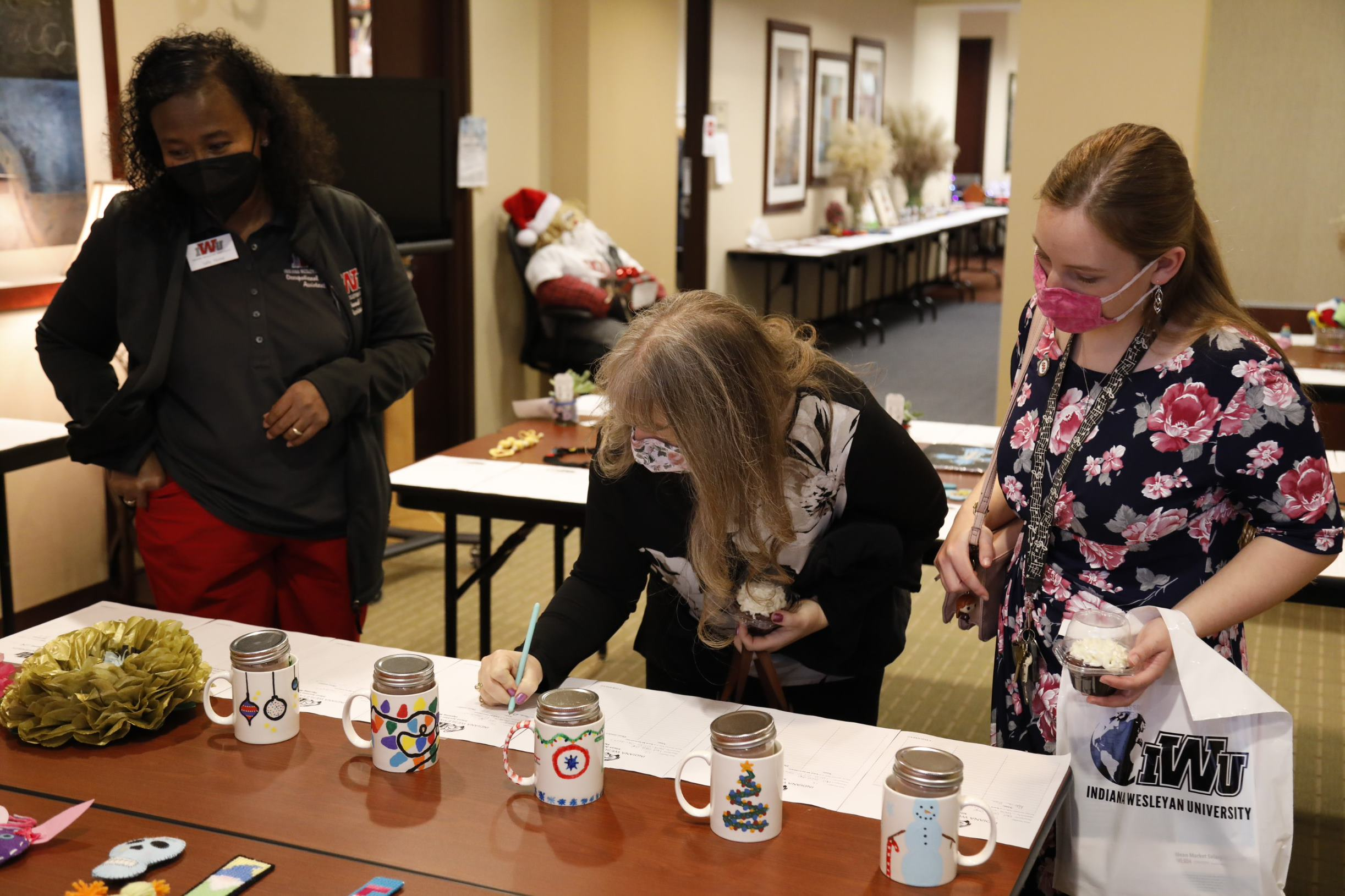 A person writes a note on a table.