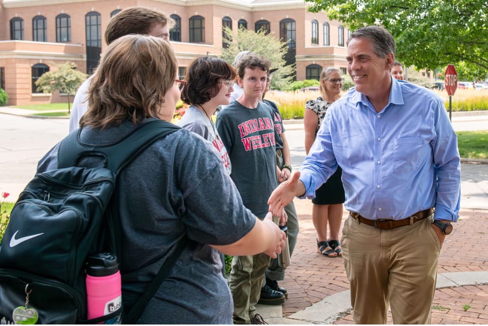 Donald Lamb shaking hands with students
