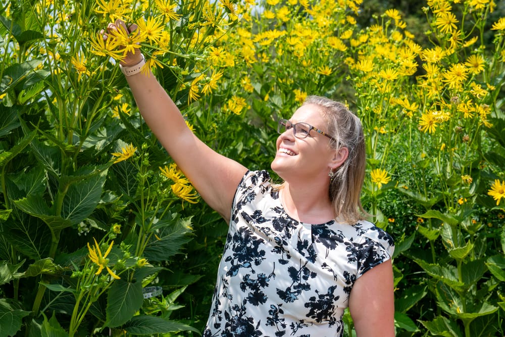 Dr. Noseworthy looking at plants in garden