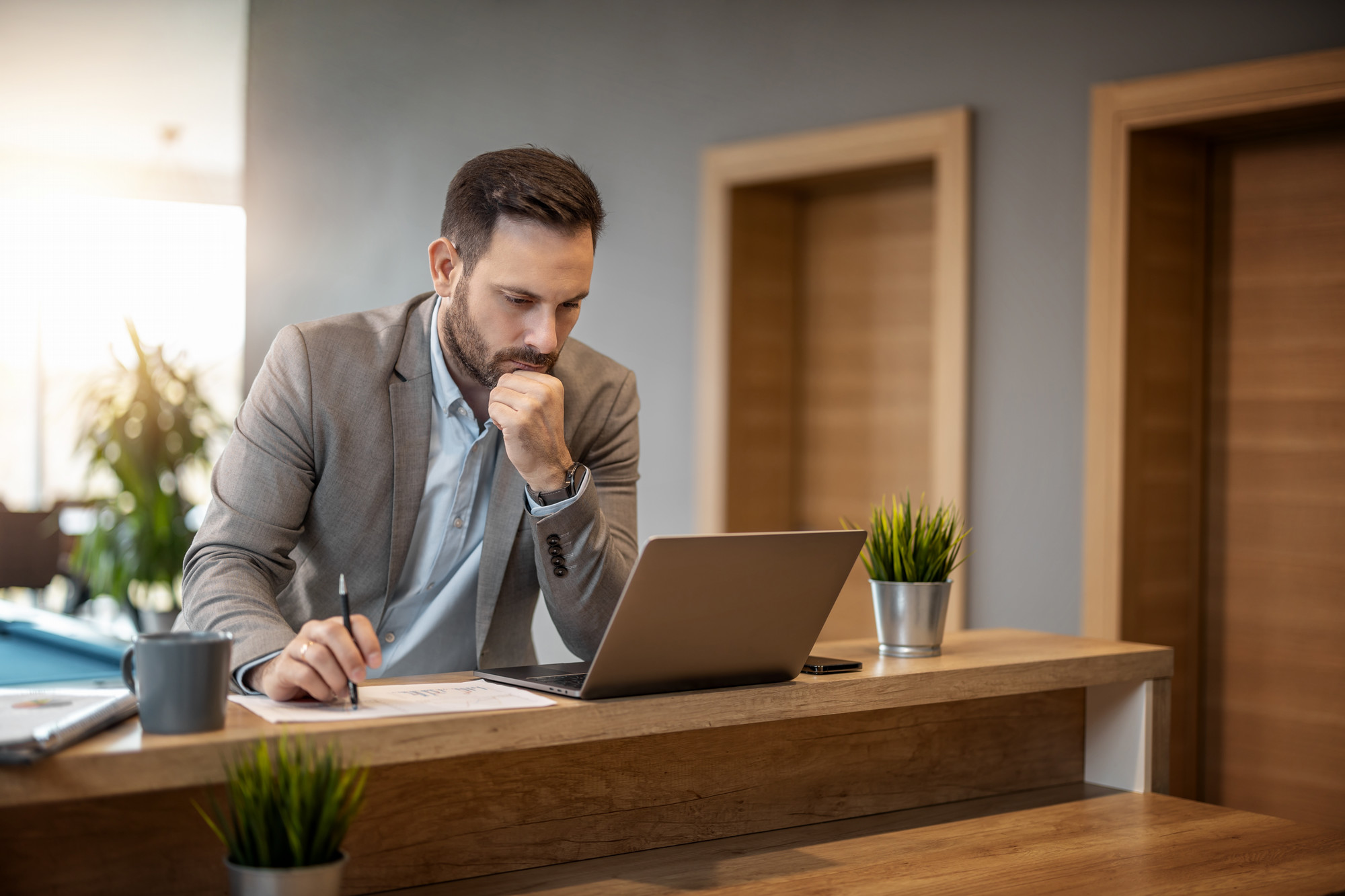 Man standing and working on laptop