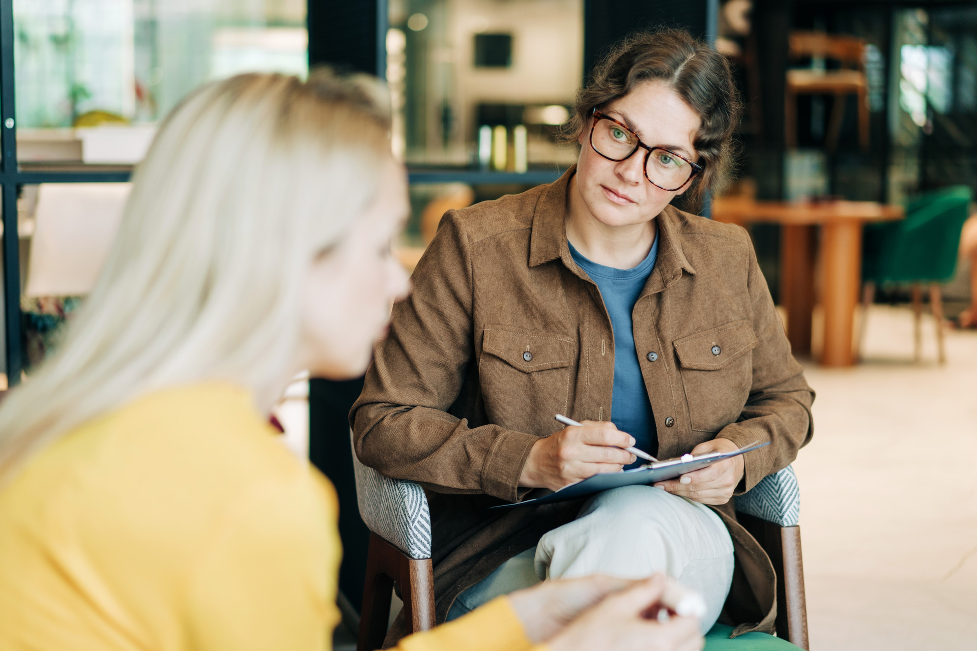 A female psychologist is counseling a depressed client.