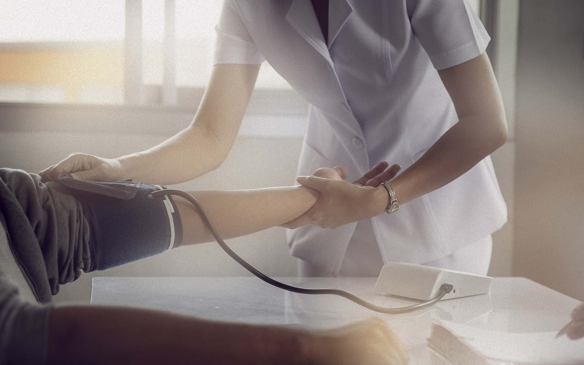 Nurse taking patient's blood pressure