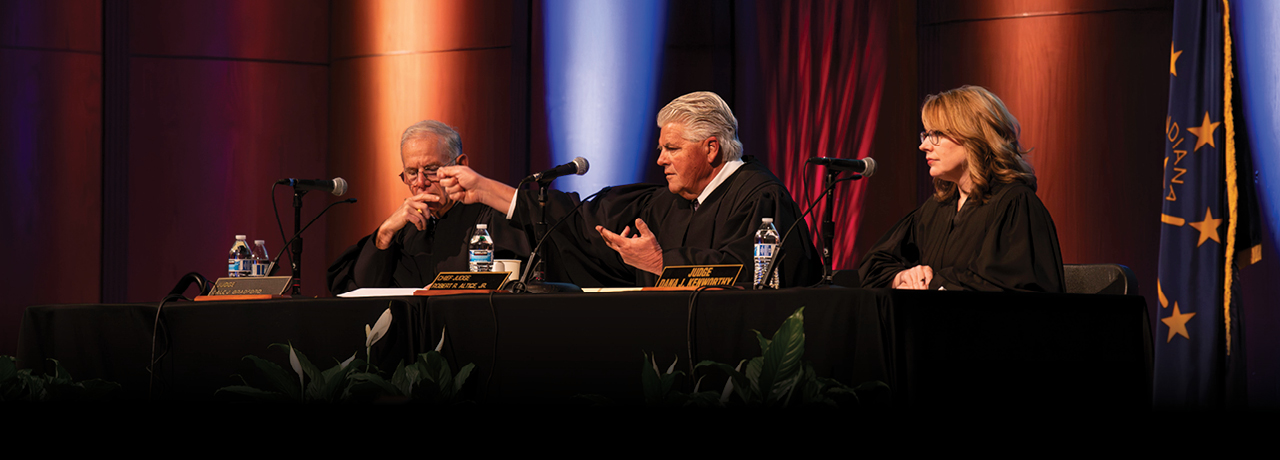 3 Judges from the court of appeals sitting at a table during deliberations