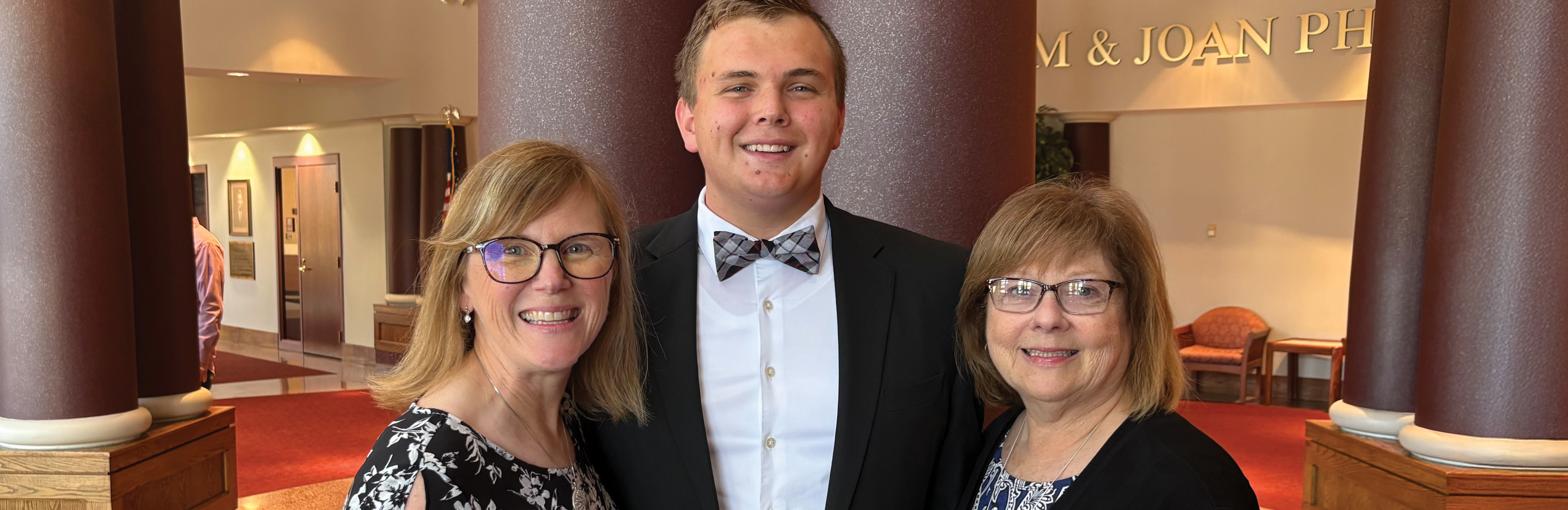 Family photo Elijah, his mother Joy, and his grandmother Gayle in the IWU theatre