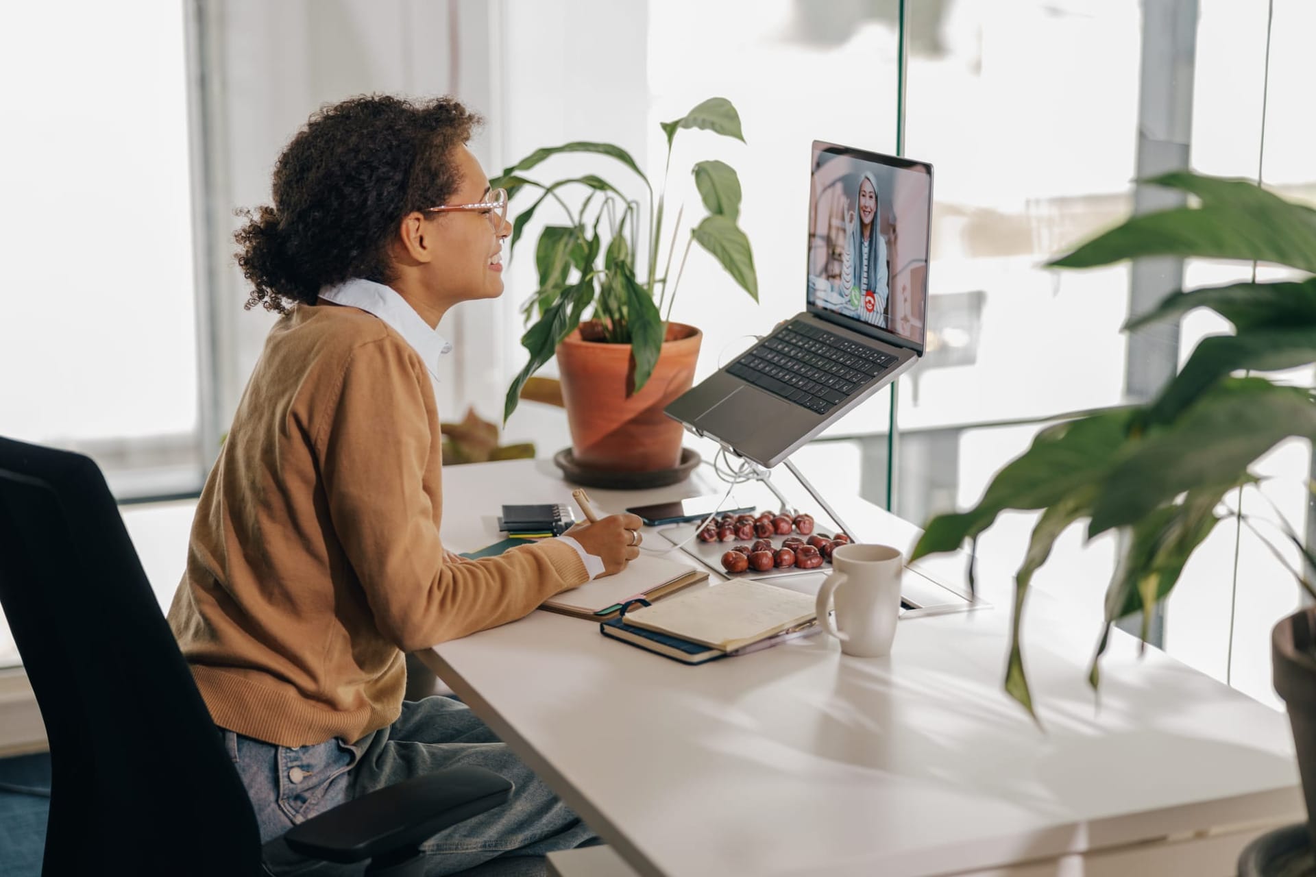 Social worker doing a video call on her laptop while sitting at desk