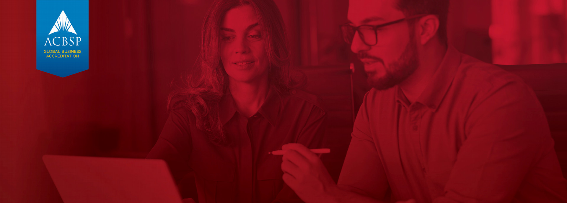 Woman and man working on computer together. 