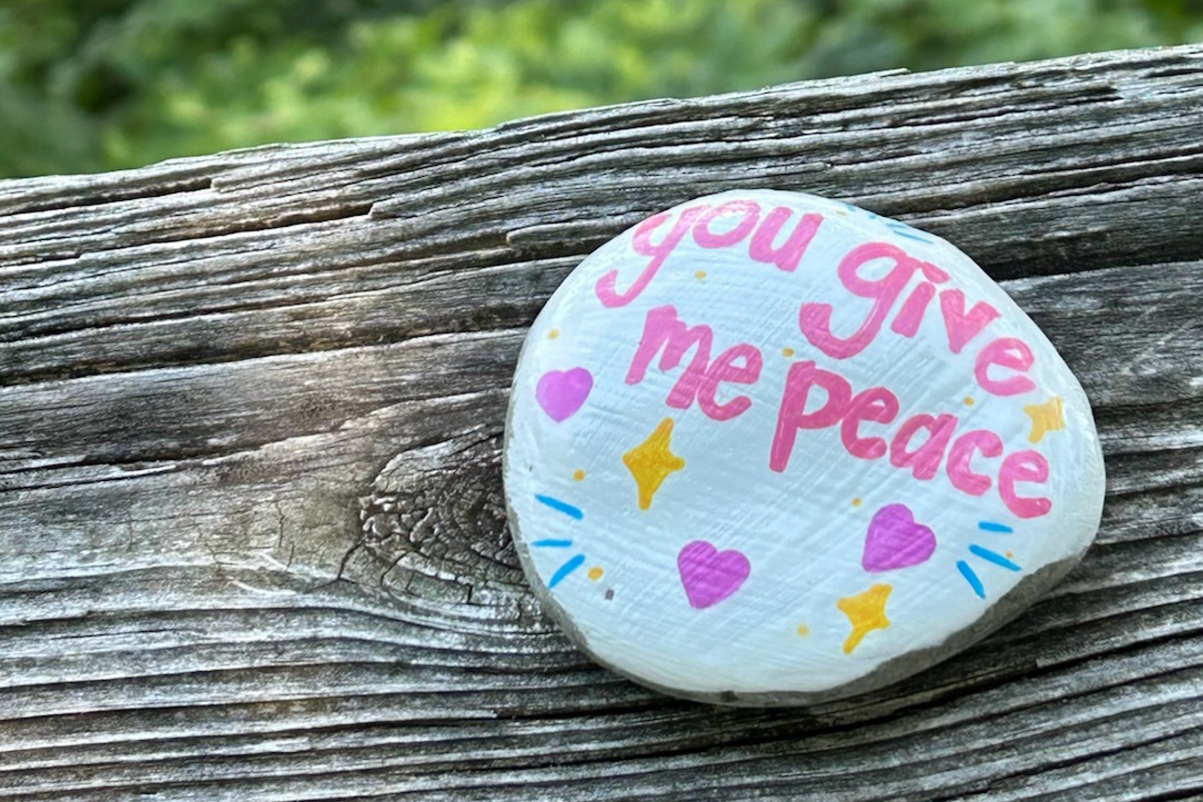 Painted rock that says "you give me peace"