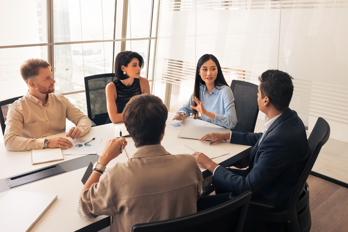 5 people meeting around a conference table
