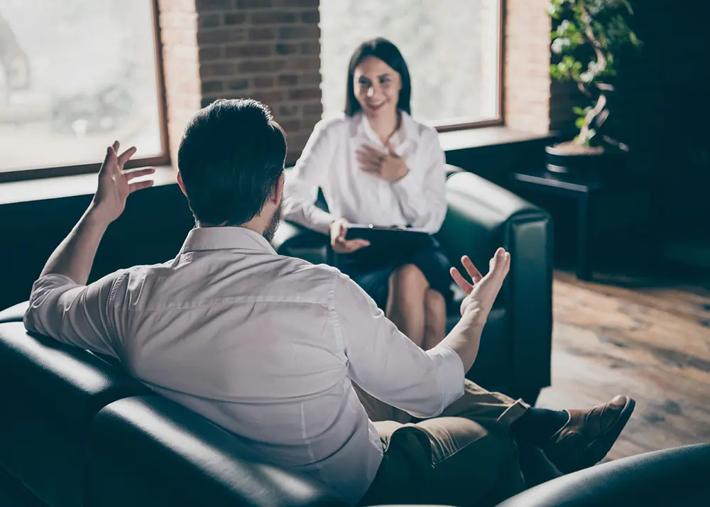 Two people talking in therapy session