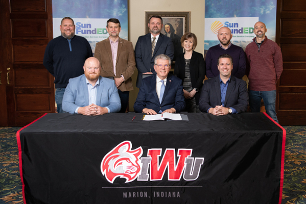 Representatives of IWU and SunFundED sign an agreement to develop solar energy systems across four campuses