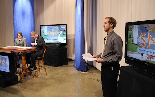 Student stands during IWU newscast