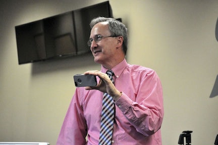 Dr. Randall E. King teaches students to shoot video on an iPhone. (photo courtesy Chronicle-Tribune)