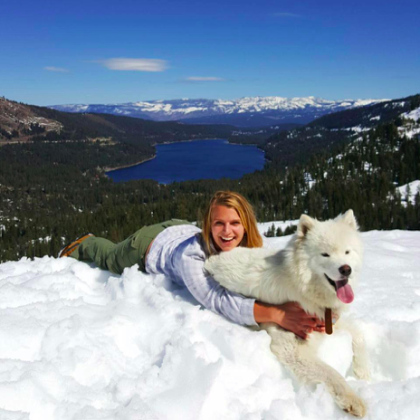 Becca with dog in snow on mountaintop